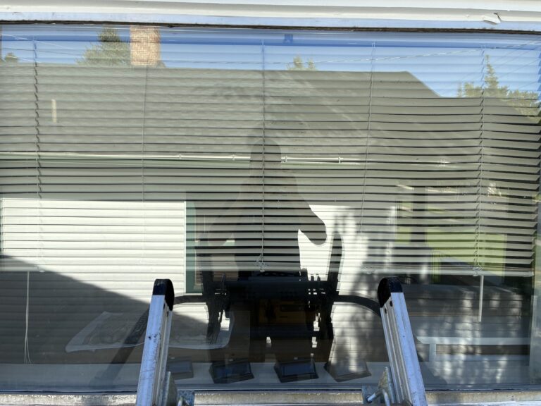 Reflection in window with blinds