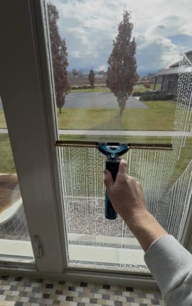 Cleaning a window with a squeegee