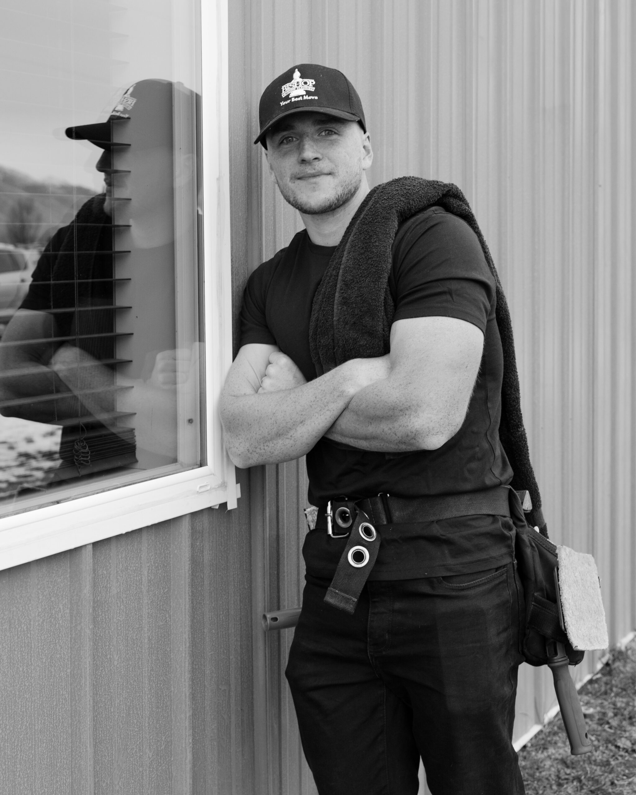 Man in black shirt, tool belt.