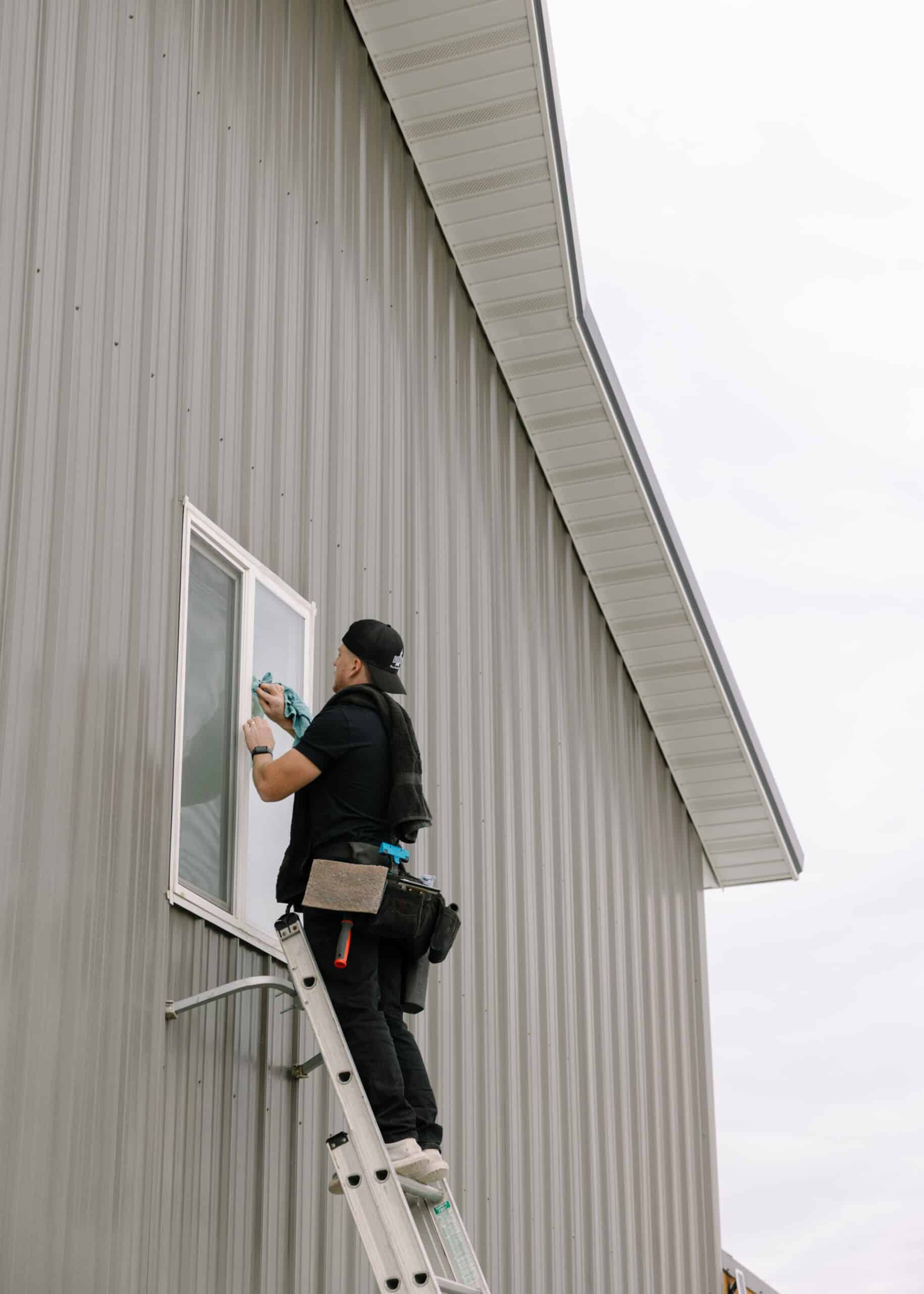 Man cleaning window on commercial building