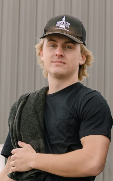 Person holding a towel, wearing cap.